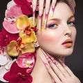 Beautiful woman with long nails, perfect skin, hair of orchids. Royalty Free Stock Photo