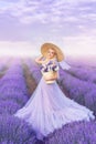 Beautiful woman in a long purple dress and a large hat in lavender. A girl with a basket of flowers in a lavender field Royalty Free Stock Photo