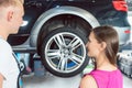 Beautiful woman looking happy at a reliable auto mechanic