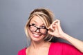 Beautiful woman looking over eyeglasses for imagination Royalty Free Stock Photo