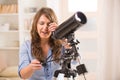 Beautiful woman looking through telescope Royalty Free Stock Photo