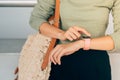 Beautiful woman looks at the clock waiting for the plane at the airport Royalty Free Stock Photo