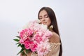 Beautiful woman with lots of pink flowers in her hands. Sexy woman with long hair Royalty Free Stock Photo