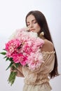 Beautiful woman with lots of pink flowers in her hands. Sexy woman with long hair Royalty Free Stock Photo