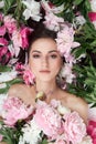 Beautiful woman with lots of pink flowers in her hands. Sexy woman with long hair Royalty Free Stock Photo