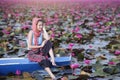 Beautiful woman with lotus flower at the red lotus sea Royalty Free Stock Photo