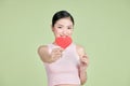 Beautiful woman in love and holding heart shape, exhilarated woman holding a valentine greeting card in hands Royalty Free Stock Photo