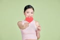 Beautiful woman in love and holding heart shape, exhilarated woman holding a valentine greeting card in hands