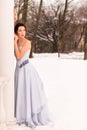 Beautiful woman in a luxurious blue fairy-tale dress in a snowy forest Royalty Free Stock Photo