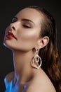 Beautiful woman in luxury fashion earrings. Diamond shiny jewelry with brilliants. Accessories jewelery, fashion makeup