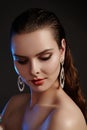 Beautiful woman in luxury fashion earrings. Diamond shiny jewelry with brilliants. Accessories jewelery, fashion makeup