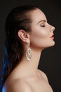 Beautiful woman in luxury fashion earrings. Diamond shiny jewelry with brilliants. Accessories jewelery, fashion makeup