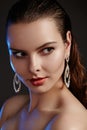 Beautiful woman in luxury fashion earrings. Diamond shiny jewelry with brilliants. Accessories jewelery, fashion makeup