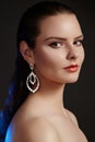 Beautiful woman in luxury fashion earrings. Diamond shiny jewelry with brilliants. Accessories jewelery, fashion makeup Royalty Free Stock Photo