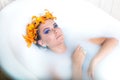 Beautiful woman lying in bath with flowers Royalty Free Stock Photo