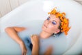 Beautiful woman lying in bath with flowers Royalty Free Stock Photo