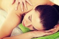 Beautiful woman lying on bed in spa salon. Royalty Free Stock Photo