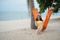 Woman lying on the cradle at the beach