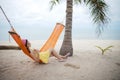 Woman lying on the cradle at the beach