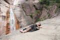 Beautiful woman lying on the rock and has a rest on mountain
