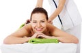 Beautiful woman lying on spa salon having stone massage. Royalty Free Stock Photo