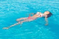 Beautiful woman lying on swimming pool water surface Royalty Free Stock Photo