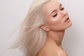 Beautiful woman with magnificent blond hair. Happy model face with windswept flying hair. Shiny long health hairstyle Royalty Free Stock Photo