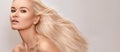 Beautiful woman with magnificent blond hair. Happy model face with windswept flying hair. Shiny long health hairstyle Royalty Free Stock Photo