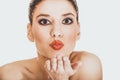 Beautiful woman with make up blowing a kiss. Royalty Free Stock Photo