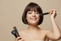 beautiful woman makeup brushes in hand model makeup posing isolated background Royalty Free Stock Photo