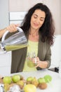 beautiful woman making fruits smoothies with blender Royalty Free Stock Photo