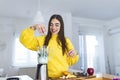 Beautiful woman making fruits smoothies with blender. Healthy eating lifestyle concept. Young woman preparing drink with bananas,