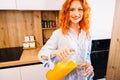 Beautiful woman making orange juice. Healthy eating lifestyle concept portrait of beautiful young woman preparing juice Royalty Free Stock Photo