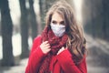 Beautiful woman in medical protective face mask outdoors