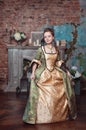 Beautiful woman in medieval dress doing curtsey