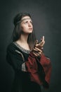 Beautiful woman in medieval dress praying