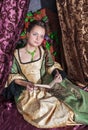 Beautiful woman in medieval dress reading book Royalty Free Stock Photo