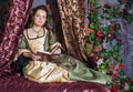 Beautiful woman in medieval dress reading book Royalty Free Stock Photo