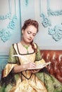 Beautiful woman in medieval dress writing in diary Royalty Free Stock Photo