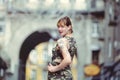 Beautiful woman in military dress in city and tattoo on hands