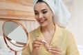 Beautiful woman with mirror applying makeup Royalty Free Stock Photo