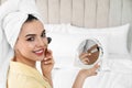 Beautiful woman with mirror applying makeup Royalty Free Stock Photo