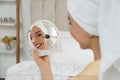 Beautiful woman with mirror applying makeup in bedroom Royalty Free Stock Photo