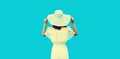 Beautiful woman model wearing white summer straw hat on blue background, rear view Royalty Free Stock Photo