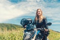 Beautiful woman on a motorcycle looking at the road ahead Royalty Free Stock Photo