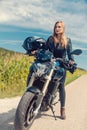 Beautiful woman on a motorcycle looking at the road ahead Royalty Free Stock Photo