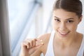 Beautiful Woman Mouth Holding Pill For Teeth. Girl Taking Vitamins Royalty Free Stock Photo