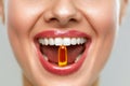 Beautiful Woman Mouth With Pill In Teeth. Girl Taking Vitamins Royalty Free Stock Photo