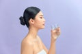 Beautiful woman with naked shoulders drinking a glass of water Royalty Free Stock Photo