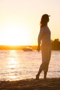 Beautiful woman in natural white shirt looking to the golden sun Royalty Free Stock Photo